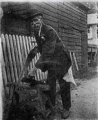 Alfred Taylor sawing wood in the yard